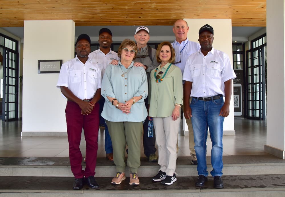 Larry and Ellen Bell with Emmanuel (in green) and his family. The Bells sponsor Emmanuel and all his siblings in Zambia.
