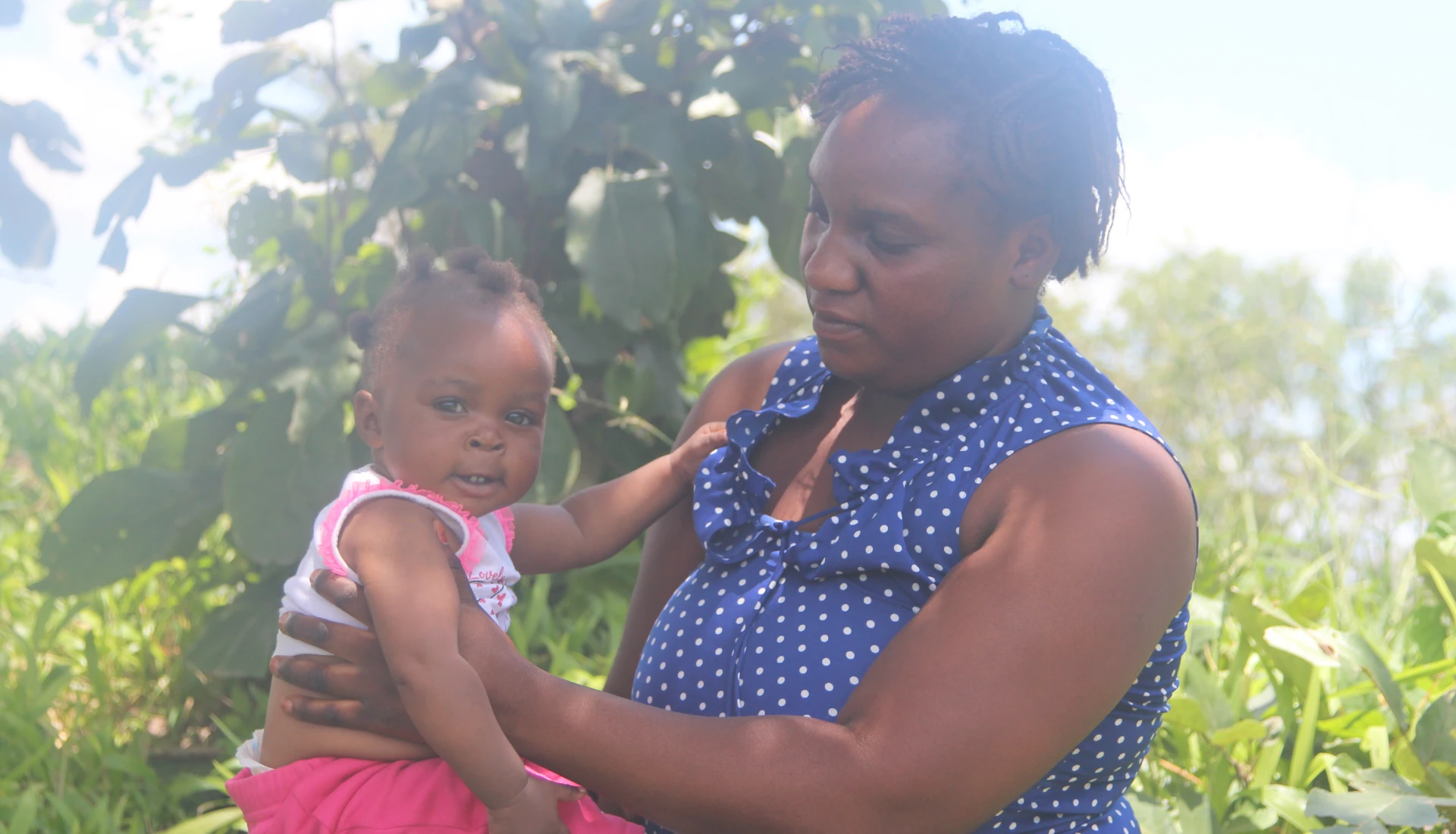 Another recipient, Martha from Chibombo show off the clothes her baby received